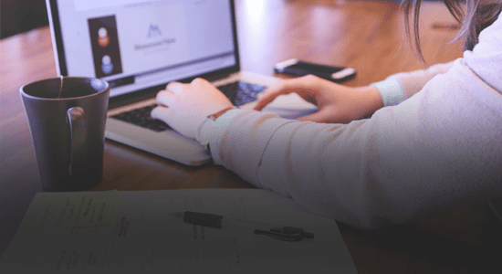 Man typing at a laptop computer, image to accompany duplicate content blog post.