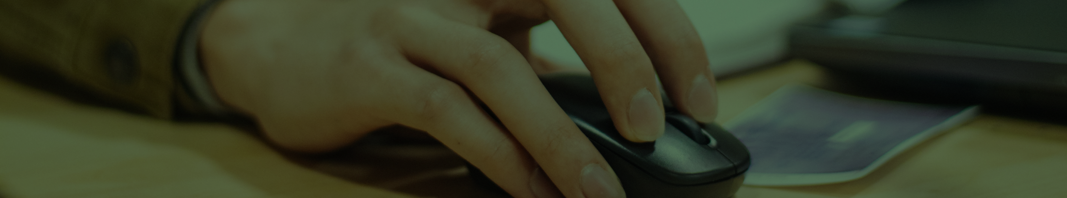 A photo focused on a hand using a computer mouse.