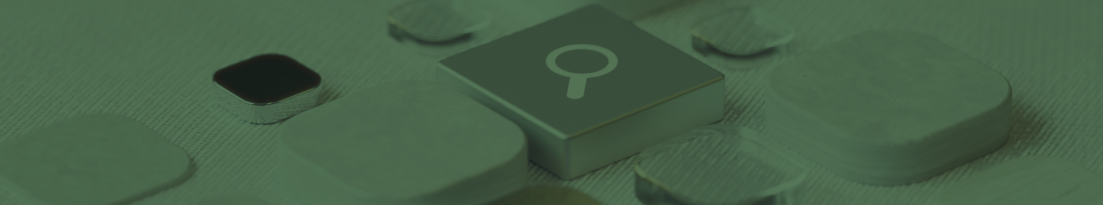 An abstract representation of AI search technology, using a variety of different tiles surrounding a central silver tile featuring the search magnifying glass.