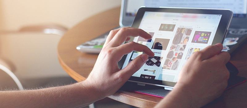 A person browsing the internet on a tablet.